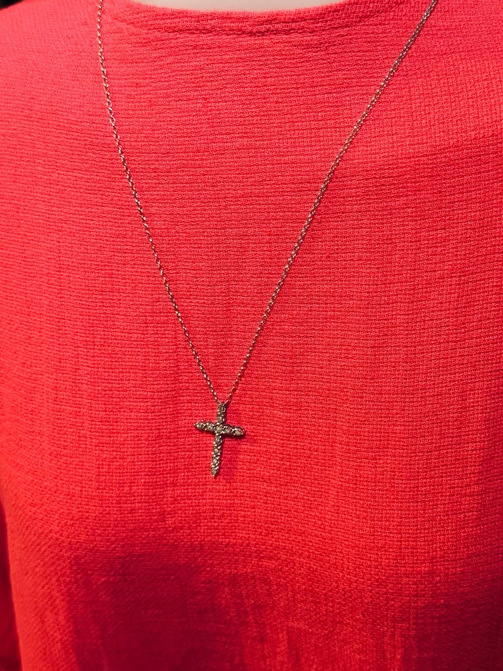 White gold necklace and diamond cross charm.